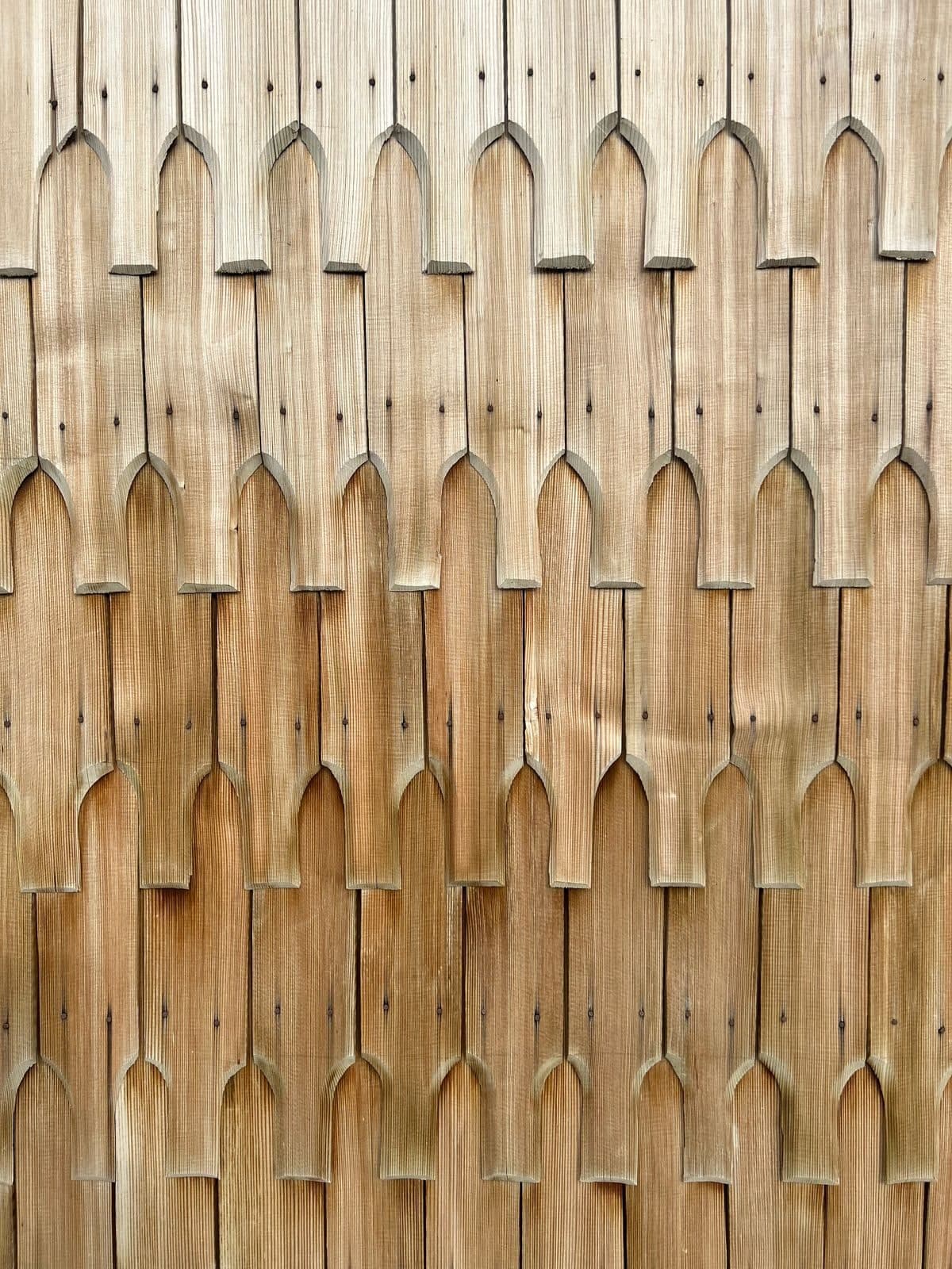 Traditional carved wood shingle facade detail